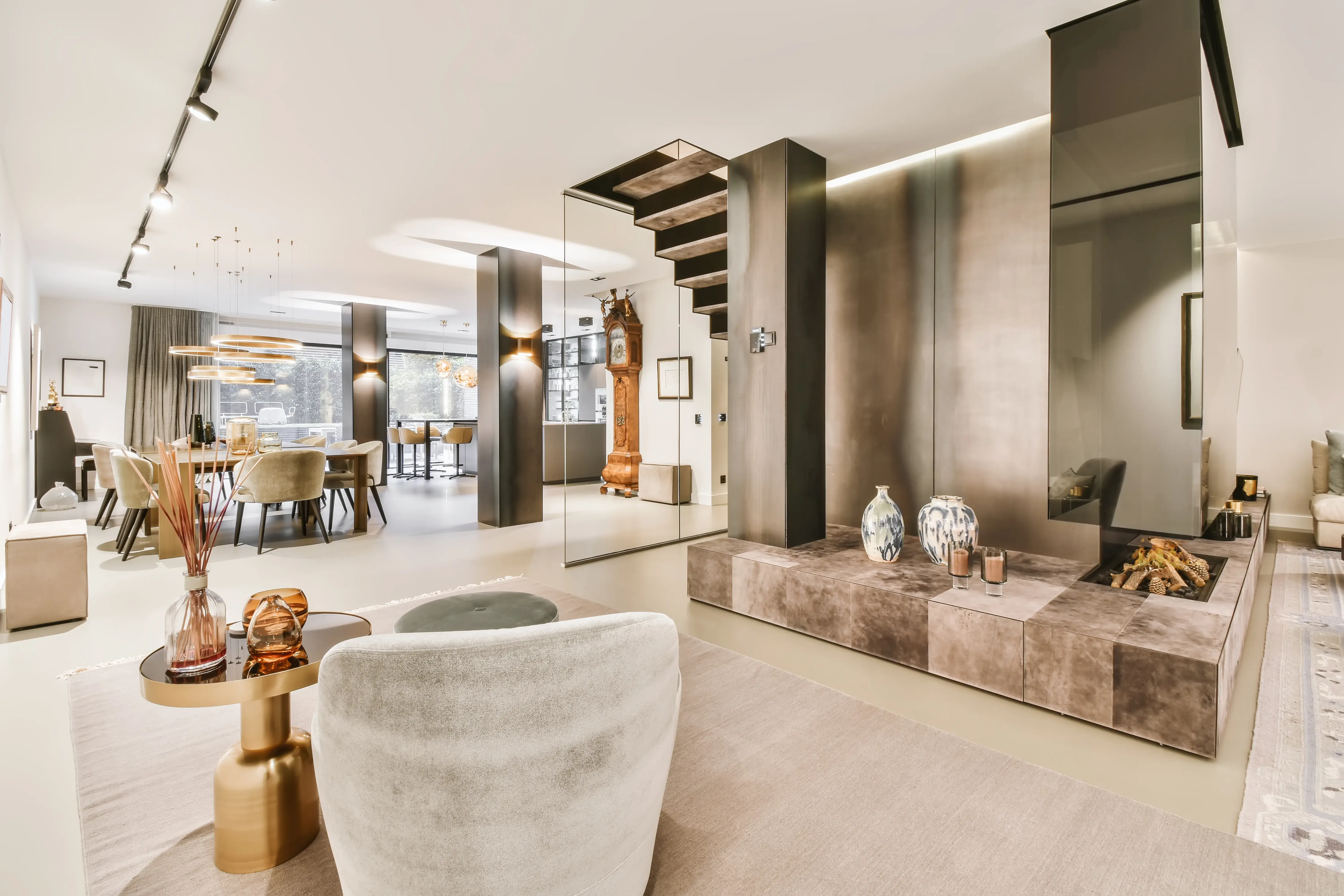 A modern living room with a fireplace and warm neutral tones